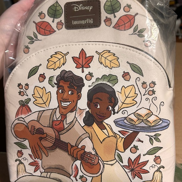 Loungefly Handbags - Loungefly Cream Backpack with Tiana and Naveen Design